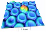 Figure 1. Three-dimensional view of boron nitride nanomesh on Rh(111) with one Cu-phthalocyanine molecule trapped in a pore.
